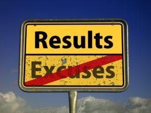 Street sign striking 'Excuses' and writing 'Results'